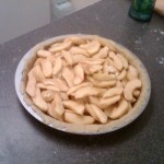 Filling apple pie.